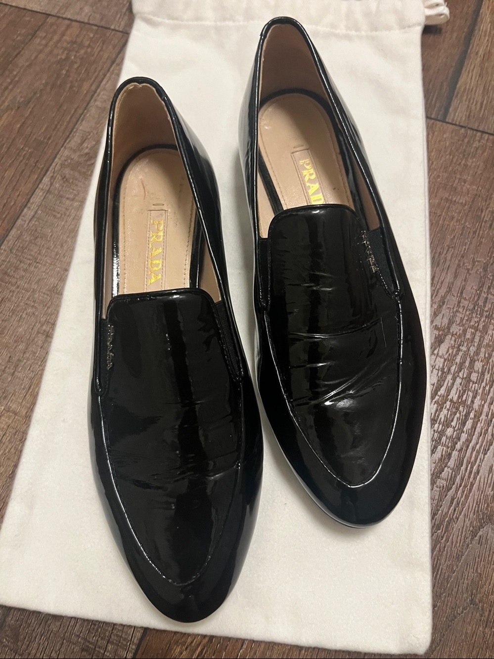 Prada Black Patent Leather Slip-On Loafers with Gold Logo